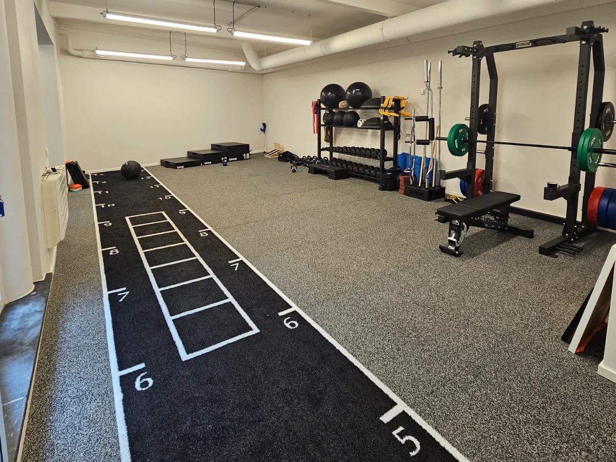 Rehabilitation space with sprint track and strength equipment